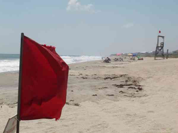 Red flags warn swimmers from the water at Kure...