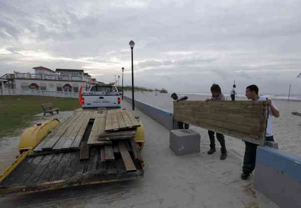 Town workers, from right, Jose Pineda, Travis...