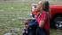 A woman carries an injured child to a triage center near the Plaza Towers Elementary School in Moore, Okla., Monday, May 20, 2013.