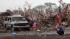 People react in front of the Plaza Towers Elementary school in Moore following a deadly tornado, May 20, 2013.