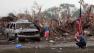 People react in front of the Plaza Towers Elementary school in Moore following a deadly tornado, May 20, 2013.
