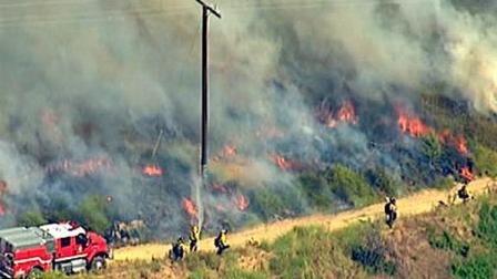 Firefighters scrambled to contain a brush fire in the Brea area on Thursday, July 7, 2011.