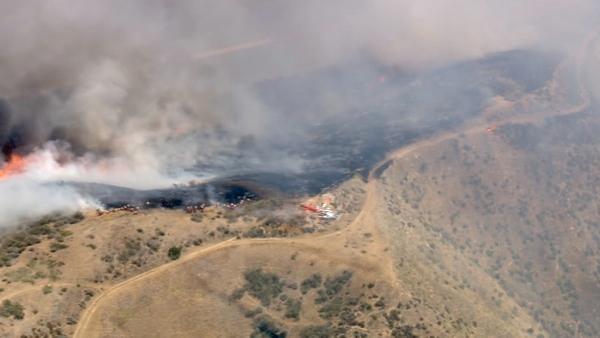 Smoke rises above the hills of Castaic, where a brush fire broke out along Interstate 5 on Friday, June 8, 2012. Fanned by winds, the blaze grew from 3 acres to more than 50 in less than three hours.