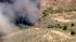 A brush fire burns in the Castaic hills on...