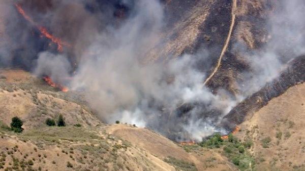 Smoke rises above the hills of Castaic, where a brush fire broke out along Interstate 5 on Friday, June 8, 2012. Fanned by winds, the blaze grew from 3 acres to more than 50 in less than three hours.