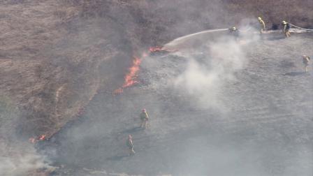 Fire crews battle a grass fire in Walnut on Monday, July 23, 2012.