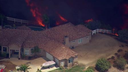A brush fire threatened a residence in Murrieta on Wednesday, Aug. 1, 2012.