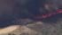A brush fire threatened a residence in Murrieta...