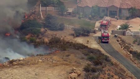 A brush fire threatened a residence in Murrieta on Wednesday, Aug. 1, 2012.