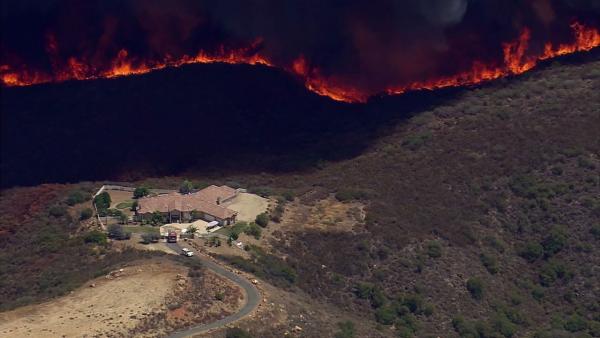 A brush fire threatened a residence in Murrieta on Wednesday, Aug. 1, 2012.