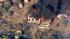 A home goes up in flames in as a brush fire...