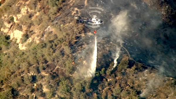 A helicopter makes a water drop over a wildfire burning in the San Gabriel Mountains above Glendora on Sunday, Sept. 2, 2012. About 1,500 recreationists and residents were evacuated in that part of the wilderness.