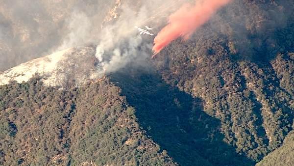 A small plane makes a drop over a wildfire in the San Gabriel Mountains above Glendora on Sunday, Sept. 2, 2012. About 1,500 recreationists and residents were evacuated in that part of the wilderness.
