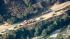 Authorities gather near where a wildfire was...