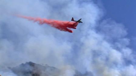 A plane drops flame retardant over a fire that broke out in the Painted Cave area above Santa Barbara on Wednesday, Oct. 17, 2012.