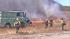 Fire crews are seen battling a blaze off the 15 Freeway in Fontana on Friday, Oct. 26, 2012.