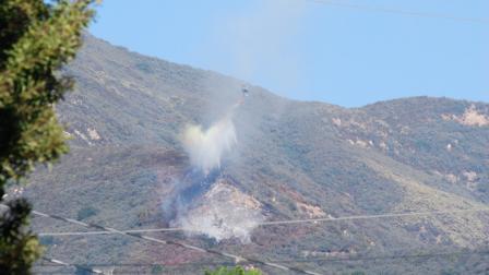 An aircraft makes a waterdrop on a brush fire that erupted in the foothills above Montecito on Tuesday, Nov. 6, 2012.