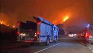 Firefighter rush to the scene of a wildfire burning in Camarillo on Thursday, May 2, 2013.