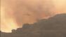 A water-dropping helicopter is seen battling the Springs Fire on Friday, May 3, 2013.