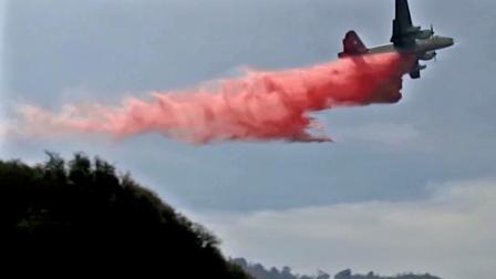 A water tanker drops Phos-Chek fire retardant on the Springs Fire on Friday, May 3, 2013.