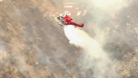 A helicopter douses a fire that erupted in Glendale on Friday, May 3, 2013.