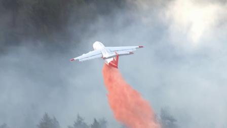 An aircraft drops fire retardant on a wildfire burning in Kern County near Frazier Mountain Park Road and the Interstate 5 Freeway on Wednesday, May 15, 2013.