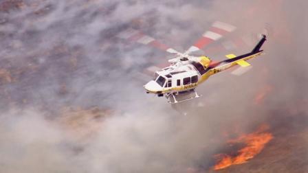 A helicopter aids in the firefight after a brush fire erupted in Castaic on Friday, May 17, 2013.