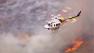 A helicopter aids in the firefight after a brush fire erupted in Castaic on Friday, May 17, 2013.