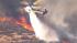 A helicopter aids in the firefight after a brush fire broke out in the Castaic area on Friday, May 17, 2013.