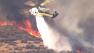 A helicopter aids in the firefight after a brush fire broke out in the Castaic area on Friday, May 17, 2013.