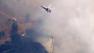 An aircraft makes a water drop on the Powerhouse Fire, which continued to burn in the Angeles National Forest north of Santa Clarita on Sunday, June 2, 2013.