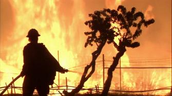 A firefighter battles a wildfire in this undated file photo.