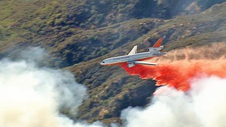 An aircraft drops fire retardant over a fire burning in the San Bernardino Mountains on Tuesday, Sept. 24, 2013.