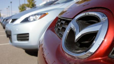 The company logo signs on the grille of a 2007 Mazda Cx-7 crossover utility vehicle on the lot of a Mazda dealer in the southeast Denver suburb of Centennial, Colo., on Sunday, Oct. 22, 2006. Year to date, Mazda North America Operations said Thursday, March 1, 2007, sales are down 1 percent to 41,332 vehicles from 41,757. Adjusted for one more selling day this year, year-to-date sales are down 3 percent. (AP Photo/David Zalubowski)