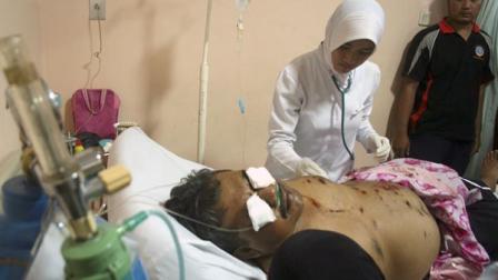 A man who was injured after a bomb went off at a police station receives medical treatment at a hospital in Cirebon, West Java, Indonesia, Friday, April 14, 2011.