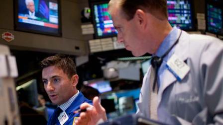 Traders work on the floor of the New York Stock Exchange on Wednesday, Aug. 3, 2011, in New York.