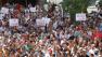 Anti-Assad demonstrators, some of them holding placards in Arabic reading