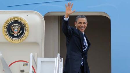President Barack Obama waves as he boards Air Force One