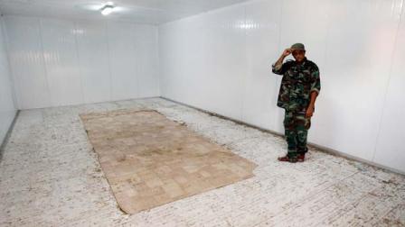 A Libyan revolutionary fighter stands in the empty freezer in a commercial center, where the body of Libyan dictator Moammar Gadhafi was displayed in Misrata, Libya,