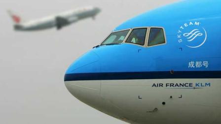 A KLM Royal Dutch Airlines Boeing 777 is parked at Chengdu airport as an Air China plane takes off behind, during a ceremony for the beginning of Chengdu to Amsterdam direct flights, in Chengdu in Chinas southwest Sichuan province Monday, May 29, 2006. KLM Royal Dutch Airlines began flights today between Chengdu and Amsterdam, which involves cooperation by KLM Royal Dutch Airlines and China Southern Airlines. (AP Photo/Color China Photo)