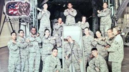 Airmen pose with a casket holding another airman wrapped in chains.