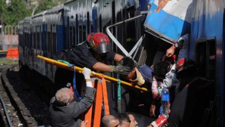Firemen rescue wounded passengers from a commuter train after a collision in Buenos Aires, Argentina, Wednesday Feb. 22, 2012