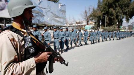 Afghan policemen march towards an anti-U.S. demonstration in Mehterlam, Laghman province east of Kabul, Afghanistan, Saturday, Feb. 25, 2012.