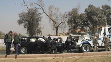 Iraqi security forces inspect the scene of a car bomb attack in the Mansour neighborhood of Baghdad, Iraq, Wednesday, March 7, 2012.