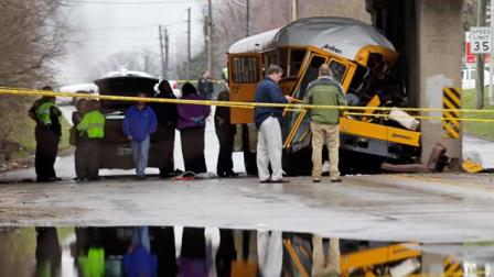 Investigators look over the scene of a fatal bus crash on the southeast side of Indianapolis, Monday, March 12, 2012.