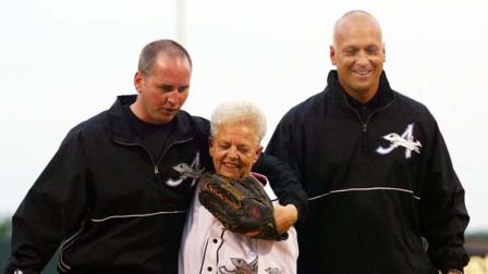 June 18, 2002 file photo shows Cal Ripken Jr., right, owner of the Aberdeen IronBirds, and his brother, Bill, walking off the field with their mother