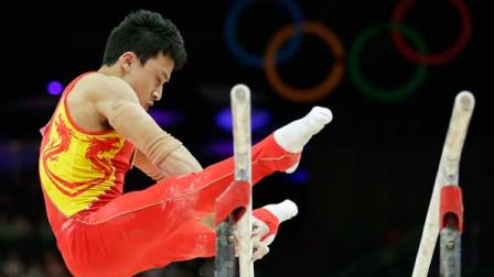 Chinese gymnast Feng Zhe performs on the parallel bars during the Artistic Gymnastic mens qualification at the 2012 Summer Olympics, Saturday, July 28, 2012, in London.