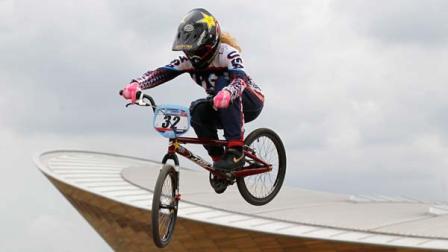 Backdropped by the velodrome U.S.s Brooke Crain jumps during the women warms-up before the start of the BMX Supercross World Cup at the Olympic Parks BMX Track in London, Saturday, Aug. 20, 2011.