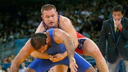 Jacob Stephen Varner of the United States, competes with Kurban Kurbanov of Uzbekistan, (in blue) during their 96-kg freestyle wrestling match at the 2012 Summer Olympics, Sunday, Aug. 12, 2012, in London.