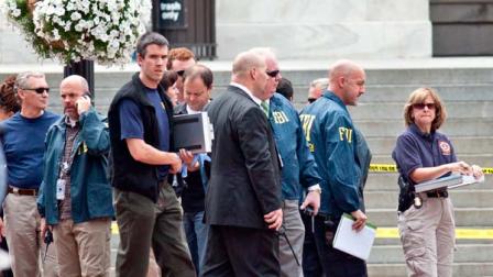 Washington Police and FBI agents gather outside the Family Research Council in Washington after security guard at the lobbying group was been shot in the arm